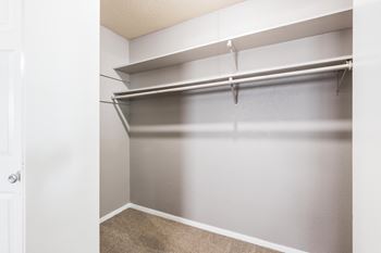 Empty white closet with shelves and a carpeted floor.at 3TEN, Springfield
